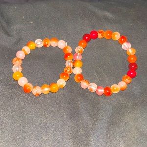 Set of red bracelets including glitter beads, solid color beads, gradient beads